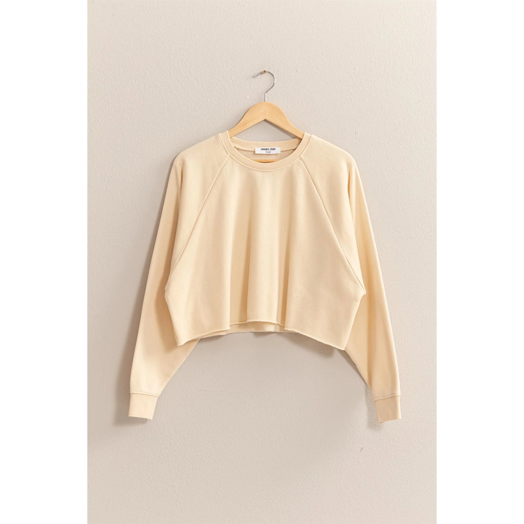 Beige sweatshirt on a hanger against a beige background